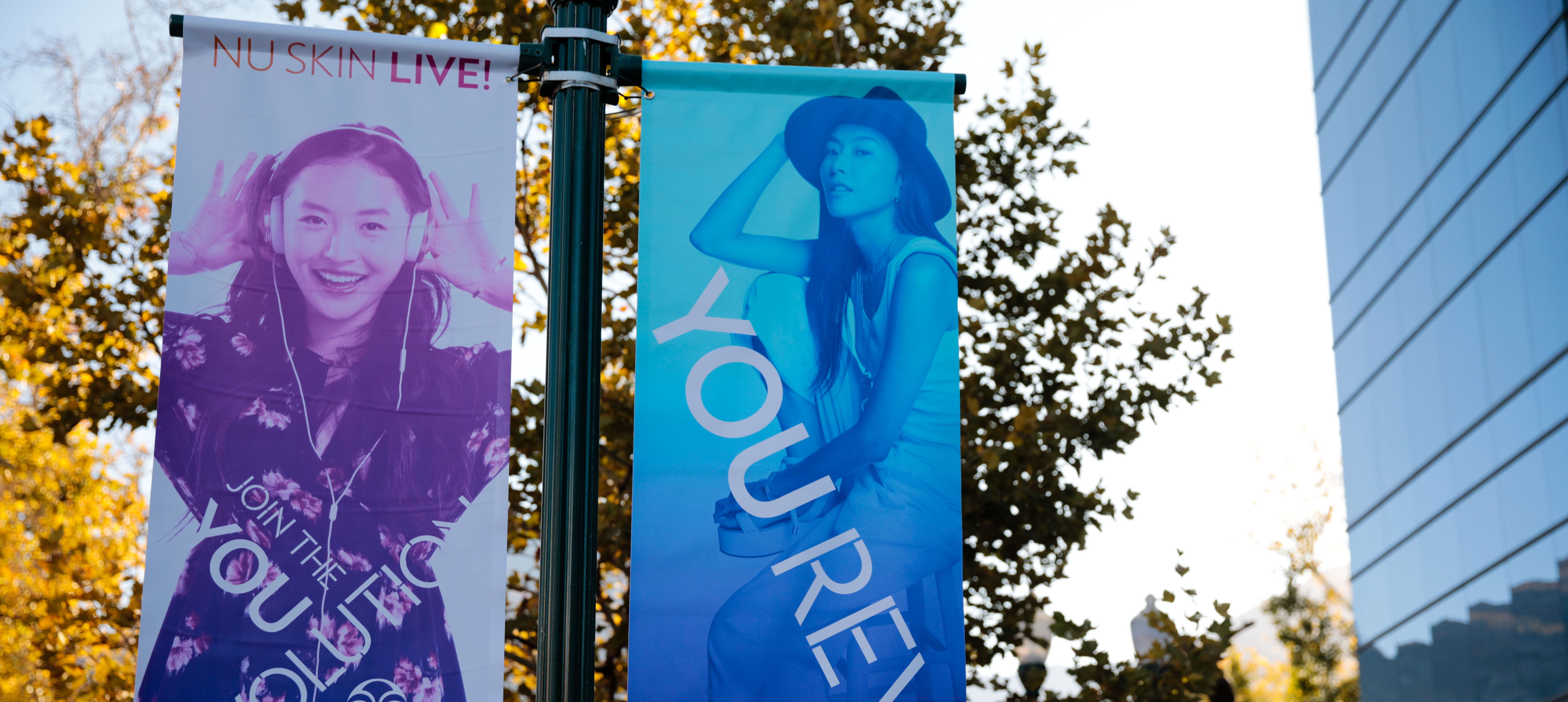 Join the You Revolution You Revolution banners hang on a light pole in front of the Nu Skin corporate office in Provo, Utah.
